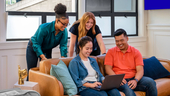 SoFi team members sitting together on a couh