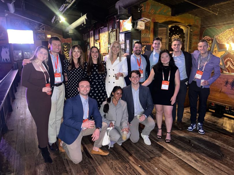 Taylor Chinitz and teammates pose for a group photo during a formal company event